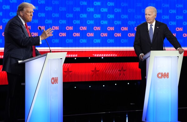 FILE - President Joe Biden, right, and Republican presidential candidate former President Donald Trump, participate in a presidential debate hosted by CNN, June 27, 2024, in Atlanta. In the ensuing two years following the pandemic, as inflation slowed but persisted, the confidence Biden hoped to instill steadily waned. And when he showed his age in a disastrous debate in June against Donald Trump, he lost the benefit of the doubt as well. That gave him the legacy of having built the legislative scaffolding of a renewed America without convincing voters that better days were ahead. (AP Photo/Gerald Herbert, File)