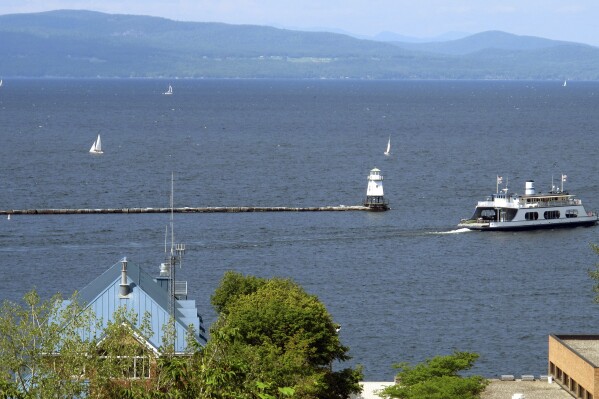 FILE - Sailboats and a passenger ferry dot Lake Champlain as seen from Battery Park, Aug. 14, 2015 in Burlington, Vt. (AP Photo/Wilson Ring, File)