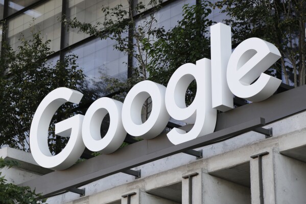 The Google sign is shown over an entrance to the company's new building in New York on Wednesday, Sept. 6, 2023. The U.S. government is taking aim at what has been an indomitable empire: Google’s ubiquitous search engine and the lucrative digital services hatched by its unwavering status as the internet’s main gateway. (AP Photo/Peter Morgan)