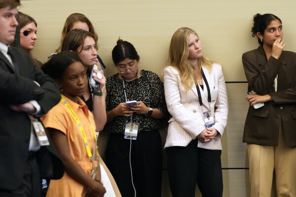 Staff members and others listen as President Joe Biden speaks at a news conference Thursday July 11, 2024, on the final day of the NATO summit in Washington. (AP Photo/Jacquelyn Martin)