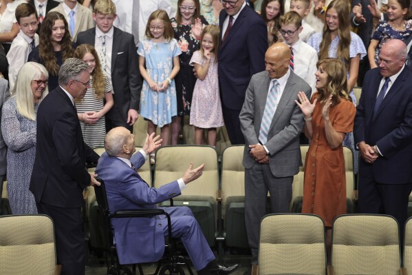 President Russell M. Nelson of The Church of Jesus Christ of Latter-day Saints greets his family prior to a photo during his 100th birthday celebration at the Little Theatre of the Conference Center in Salt Lake City, Monday, Sept. 9, 2024. (Jeffrey D. Allred/The Deseret News via AP, Pool)