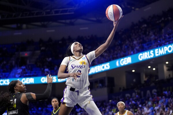 Los Angeles Sparks forward Rickea Jackson (2) leaps to the basket for a shot-attempt after getting past Dallas Wings' Arike Ogunbowale, left, in the second half of a WNBA basketball game in Arlington, Texas, Saturday, July 13, 2024. (AP Photo/Tony Gutierrez)