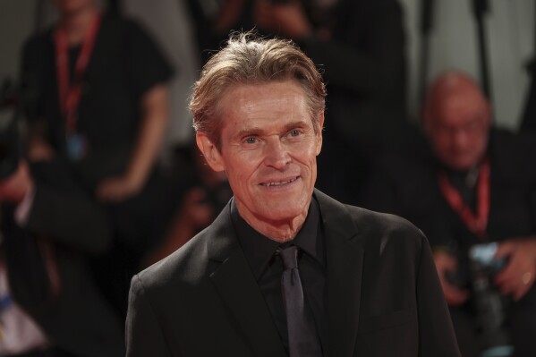 FILE - Willem Dafoe poses for photographers upon arrival at the 79th edition of the Venice Film Festival in Venice, Italy, Sept. 6, 2022. Dafoe, a frequent red-carpet star at the Venice Film Festival, was named artistic director Monday, July 8, 2024 of the Venice Biennale’s theatre department. Dafoe, who lives near Rome with his Italian wife, said the appointment came as a surprise but that he was “borne in the theatre” and trained initially as a stage actor. (Photo by Joel C Ryan/Invision/AP)