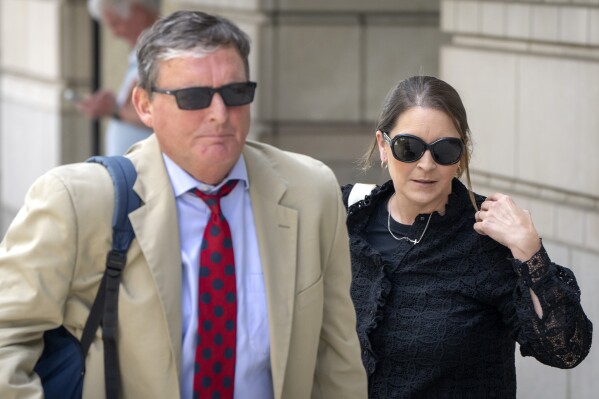 Kellye SoRelle, former general counsel for the Oath Keepers, right, and her attorney Horatio Aldredge leave federal court in Washington, Wednesday, Aug. 21, 2024. (AP Photo/Mark Schiefelbein)