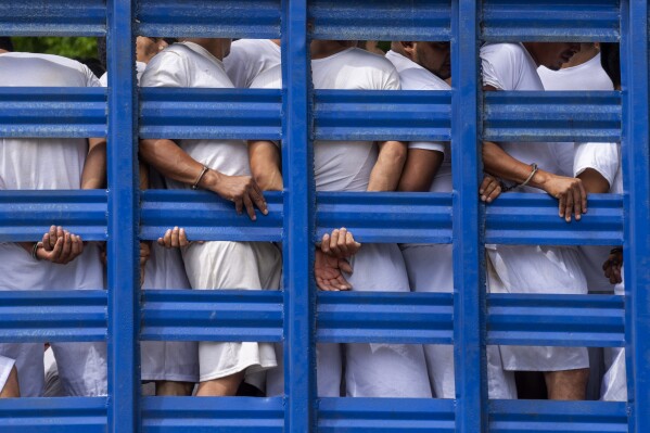 FILE - People detained by national police are transported to a detention center, in Soyapango, El Salvador, Oct. 7, 2022, during the state of the emergency declared to battle street gangs. Several nongovernmental organizations on Wednesday, Aug. 21, 2024, launched a registry of disappeared persons in El Salvador, a tool meant to help families with relatives who disappeared during the country's extended state of emergency. (AP Photo/Moises Castillo, File)