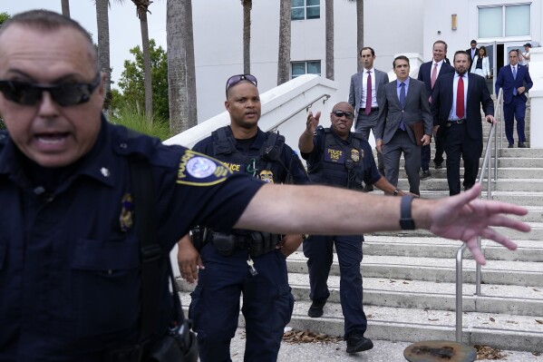 Attorneys representing former President Donald Trump,Todd Blanche, left, and Chris Kise, center, rear, leave the Alto Lee Adams Sr. U.S. Courthouse after a pretrial conference to discuss procedures for handling classified information in the case against Trump, Tuesday, July 18, 2023, in Fort Pierce, Fla. Trump is facing dozens of felony charges accusing him of illegally hoarding classified documents and thwarting the Justice Department's efforts to get the records back. (AP Photo/Lynne Sladky)