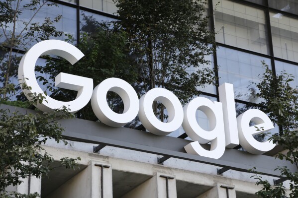 FILE - A Google sign hangs over an entrance to the company's new building, Sept. 6, 2023, in New York. (AP Photo/Peter Morgan, File)