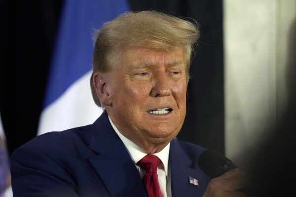 CORRECTS CIITY AND LOCATION - Former President Donald Trump visits with campaign volunteers at the Elks Lodge Tuesday, July 18, 2023, in Cedar Rapids, Iowa. (AP Photo/Charlie Neibergall)