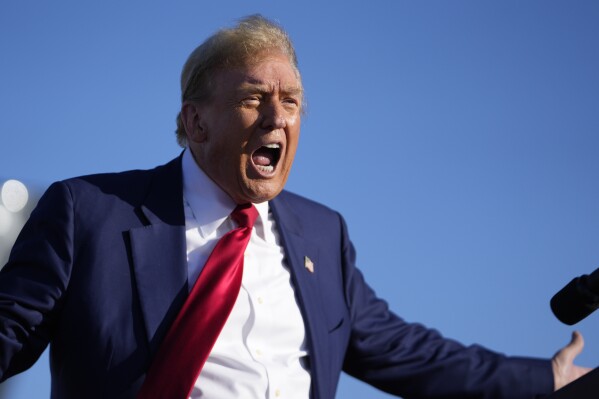 FILE - Republican presidential candidate former President Donald Trump reacts at a campaign rally in Freeland, Mich., May 1, 2024. Trump remains stuck in the courtroom listening to salacious details of an affair he denies. But another spectacle is playing out as his vice presidential tryouts get underway. The dynamic was on full display over the weekend at a fundraiser at his Mar—a-Lago club that doubled as a VP audition. (AP Photo/Paul Sancya, File)