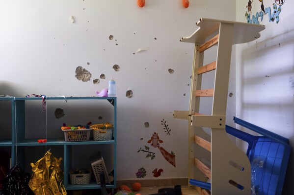 Bullet holes cover the bedroom wall of hostage Ariel Bibas, 4, in Kibbutz Nir Oz, Israel, on Friday, June 21, 2024. Ariel was kidnapped on Oct. 7, with his infant brother, Kfir, his mother, Shiri, and his father, Yarden. (AP Photo/Oded Balilty)