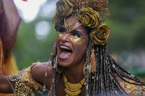 Raquel Poti performs on stilts at the "Cordao do Boitata" street pre-Carnival party in Rio de Janeiro, Brazil, Sunday, Feb. 4, 2024. (AP Photo/Silvia Izquierdo)