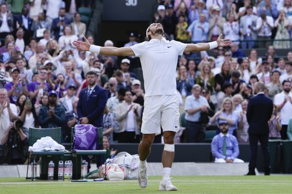 Lorenzo Musetti of Italy celebrates after defeating Taylor Fritz of the United States in their quarterfinal match at the Wimbledon tennis championships in London, Wednesday, July 10, 2024. (AP Photo/Alberto Pezzali)