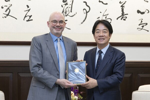 In this photo released by the Taiwan Presidential Office, Taiwan's President William Lai Ching-te, right pose for photos with American Institute in Taiwan's (AIT) director Raymond F. Greene in Taipei, Taiwan on July 10, 2024. Raymond who newly assumed his office on July 9, met with Taiwan President William Lai in the morning of July 10, when both reiterated on the strong partnership Taiwan and the U.S. nurtured from the past, with ups and downs. (Taiwan Presidential Office via AP)