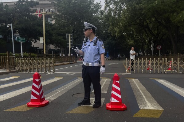 A policeman stands guard near a closed road leading to the Jingxi Hotel where the Communist Party's Central Committee is holding its third plenum in Beijing, Monday, July 15, 2024. China's ruling Communist Party is starting a four-day meeting Monday, July 15, 2024 that is expected to lay out a strategy for self-sufficient economic growth in an era of heightened national security concerns and restrictions on access to American technology. (AP Photo/Andy Wong)