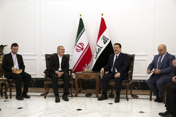 Iranian President Masoud Pezeshkian, center left, and Iraqi Prime Minister Mohammed Shia al-Sudani, center right, meet at the government palace in Baghdad, Iraq, Wednesday, Sept. 11, 2024. (Ahmed Jalil/Pool Photo via AP)