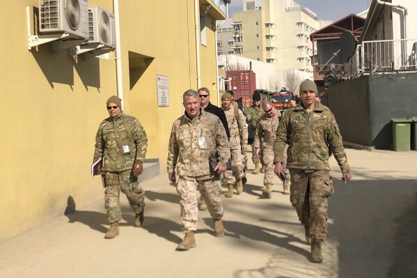 FILE - Marine Gen. Frank McKenzie, center, top U.S. commander for the Middle East, makes an unannounced visit in Kabul, Afghanistan, Jan. 31, 2020. (AP Photos/Lolita Baldor, File)