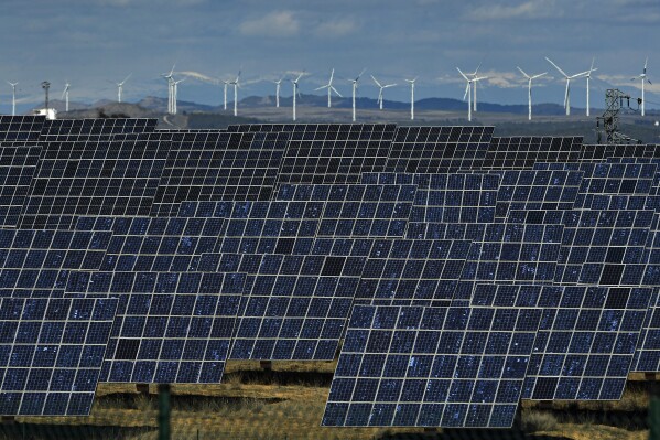 FILE - Solar panels work near the small town of Milagro, Navarra Province, northern Spain, Feb. 24, 2023. Billions of people are using different kinds of energy each day and 2023 was a record-breaking year for renewable energy sources, according to a report published Wednesday, May 8, 2024, by Ember, a think tank based in London. (AP Photo/Alvaro Barrientos, File)