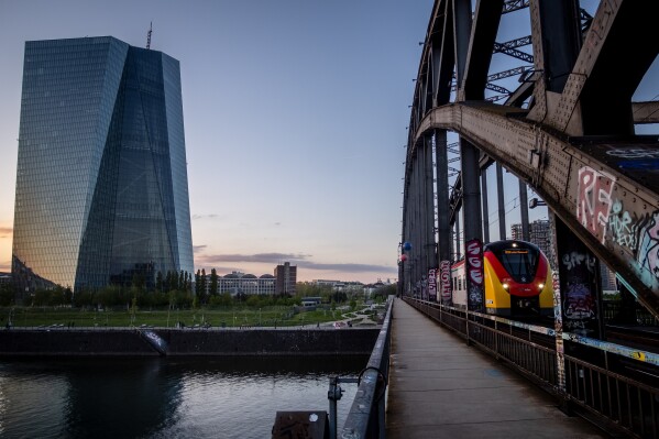 FILE - A tram drives past the European Central Bank building in Frankfurt, Germany, on May 2, 2023. European Union statistics agency Eurostat is releasing official figures on July inflation. (AP Photo/Michael Probst, File)