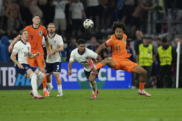 Netherlands's Joshua Zirkzee right, challenges England's Jude Bellingham during a semifinal match between the Netherlands and England at the Euro 2024 soccer tournament in Dortmund, Germany, Wednesday, July 10, 2024. (AP Photo/Darko Vojinovic)