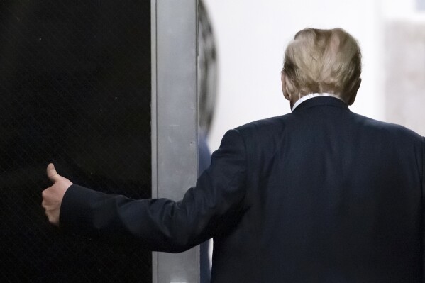 Former President Donald Trump gives a thumb up as he goes for a break during his hush money trial in New York, Tuesday, May 28, 2024. (Andrew Kelly/Pool Photo via AP)