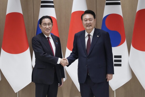 FILE - South Korean President Yoon Suk Yeol, right, shakes hands with Japanese Prime Minister Fumio Kishida during a meeting at the Presidential Office in Seoul, South Korea, on May 26, 2024. (AP Photo/Ahn Young-joon, Pool, File)