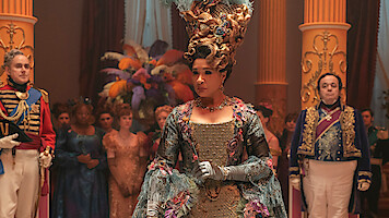 Queen Charlotte wears a blue and purple gown at a lavish ball in Season 3 of 'Bridgerton'