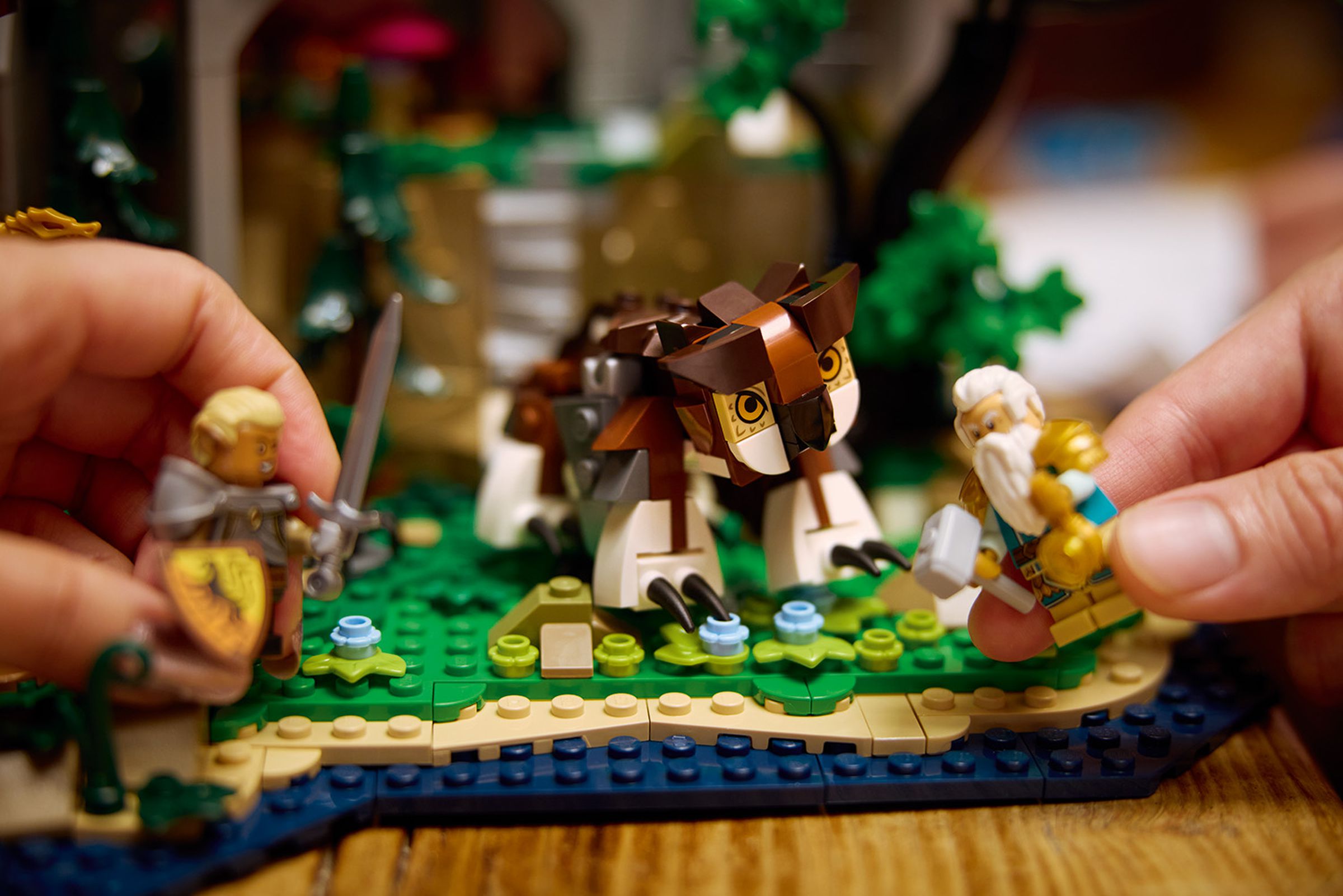 Two lego minifigs fighting a lego owlbear.