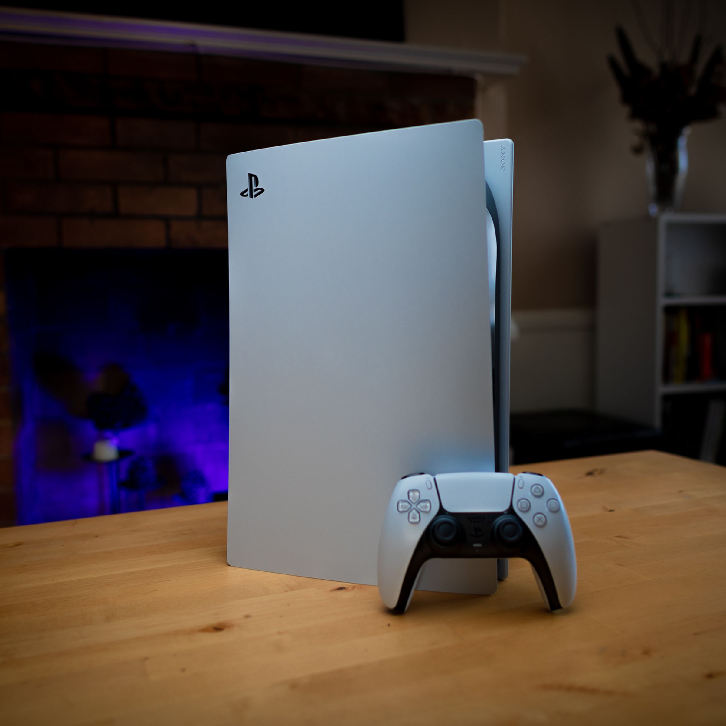 A PS5 console on a wooden table.