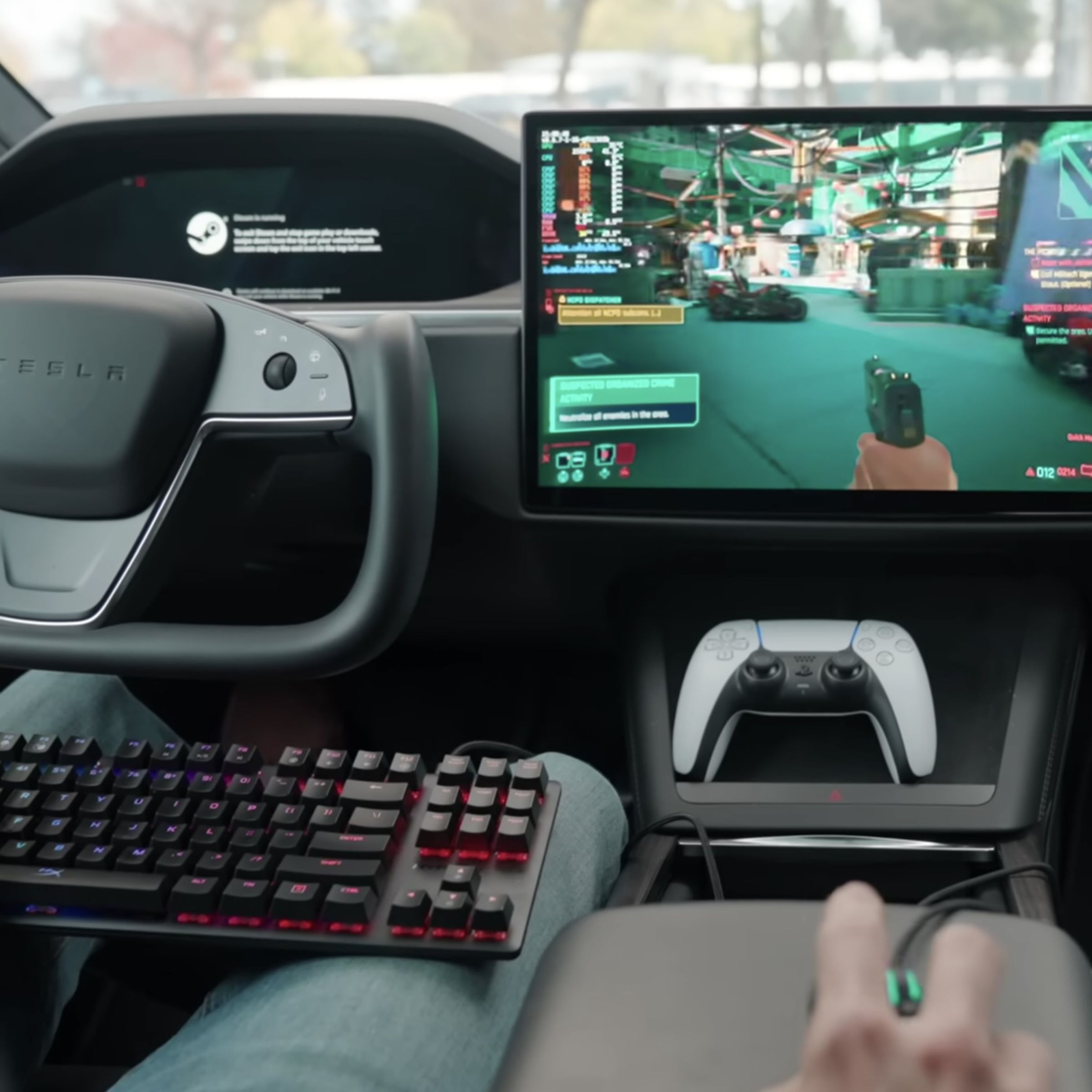 INT: driver of a Tesla model S with yoke steering wheel is parked and playing Cyberpunk 2077 steam game on the car’s infotainment screen while using a gaming keyboard in his lap, a mouse on the arm rest, and a PS5 controller sitting in the center console.