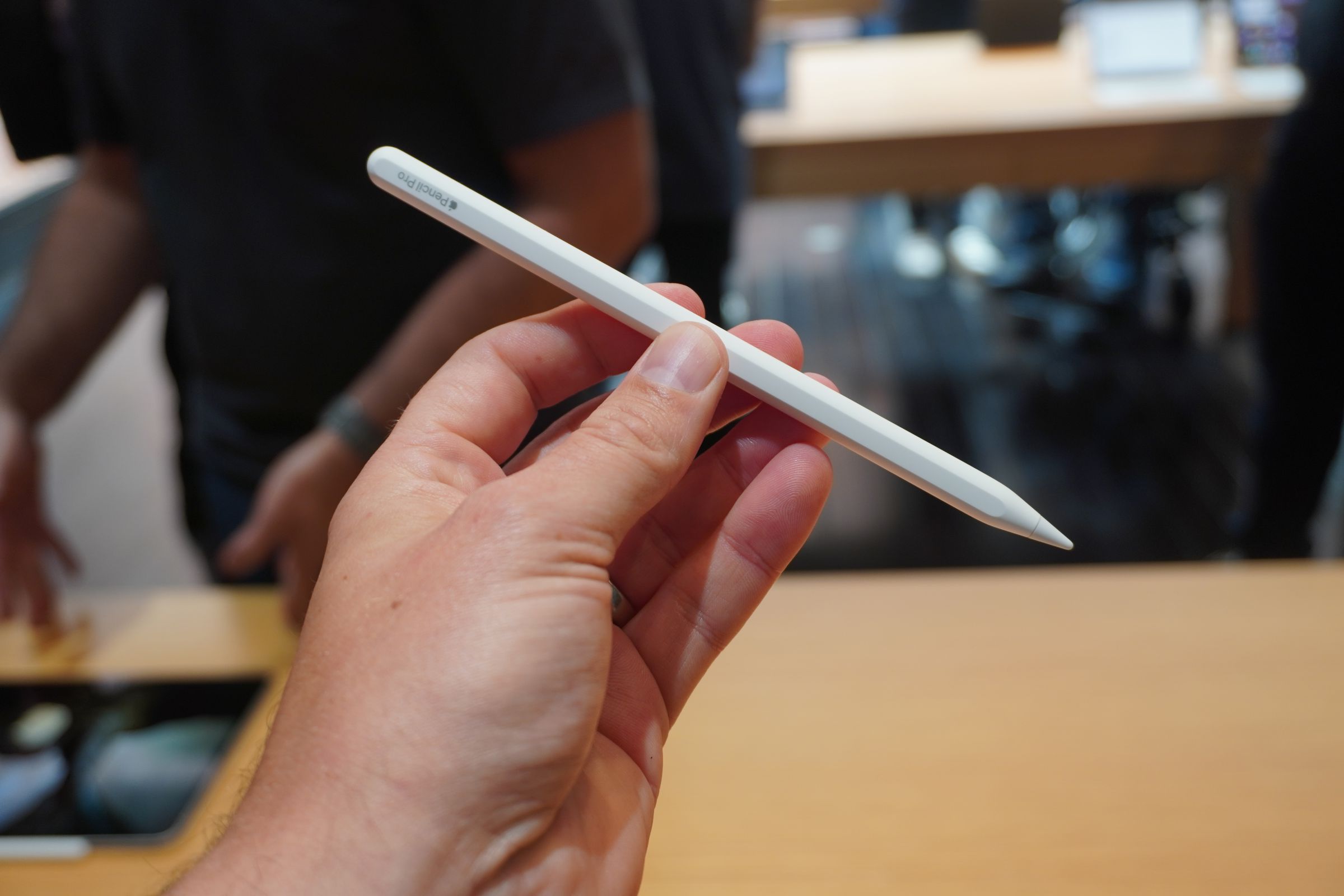 A photo of a hand holding an Apple Pencil Pro.