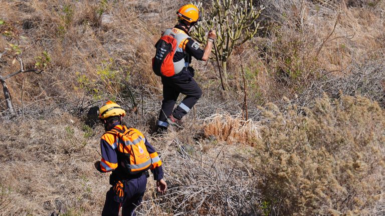 Emergency workers near the village of Masca, Tenerife.
Pic: PA