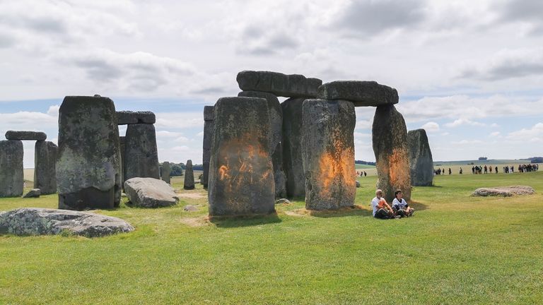 Just Stop Oil protesters spraying an orange substance on Stonehenge.
Pic:Just Stop Oil