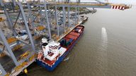 A container ship is moored next to a crane on the quayside at DP World London Gateway container port in Essex, southern England July 30, 2013. When London Gateway opens at the end of the year, it will be combine the UK's newest deep-sea container port with Europe's largest logistics park. REUTERS/Suzanne Plunkett (BRITAIN - Tags: BUSINESS POLITICS TRANSPORT)