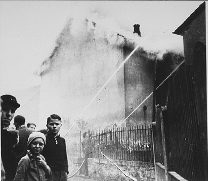 As the synagogue in Oberramstadt burns during Kristallnacht (the "Night of Broken Glass"), firefighters instead save a nearby house. [LCID: 04467]