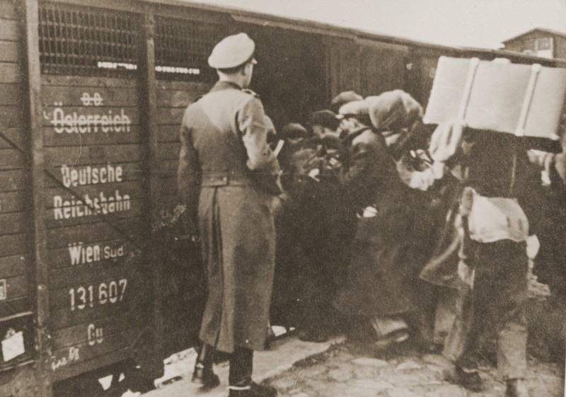 Jews are forced into boxcars destined for the Belzec killing center. [LCID: 63444]