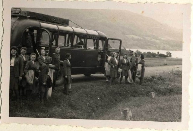 SS female auxiliaries getting off the bus on a day trip in July 1944; this image contrasts starkly with the arrival of a transport ...