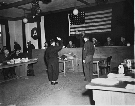 A witness is sworn in at the trial of 61 former personnel and prisoners from the Mauthausen concentration camp.