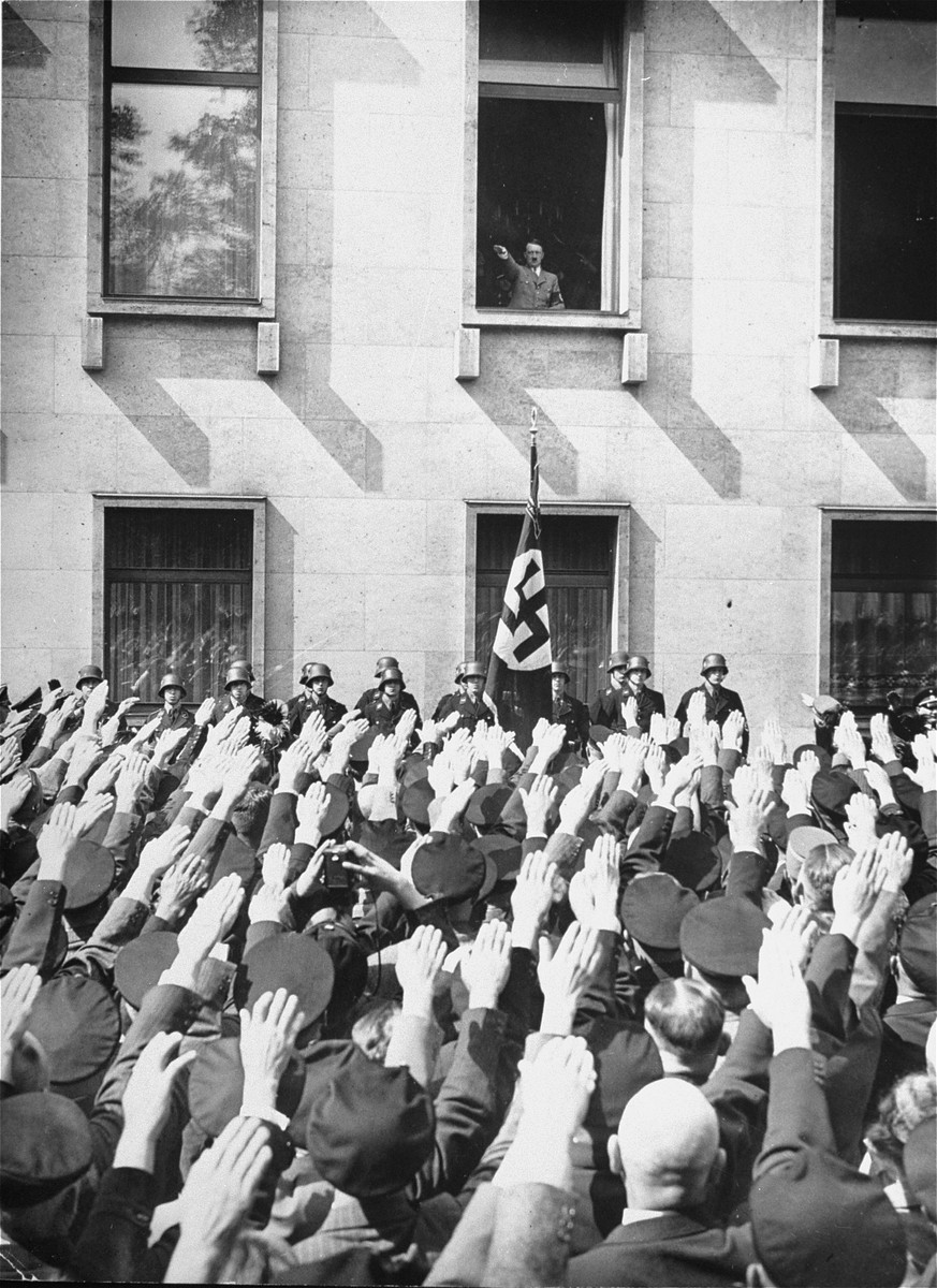 On the day of his appointment as German chancellor, Adolf Hitler greets a crowd of enthusiastic Germans from a window in the Chancellery ...