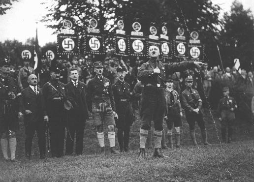  Adolf Hitler speaks at a Nazi party rally. At the time, the Nazi party was a small splinter party with little influence in the Reichstag ... [LCID: 09730]