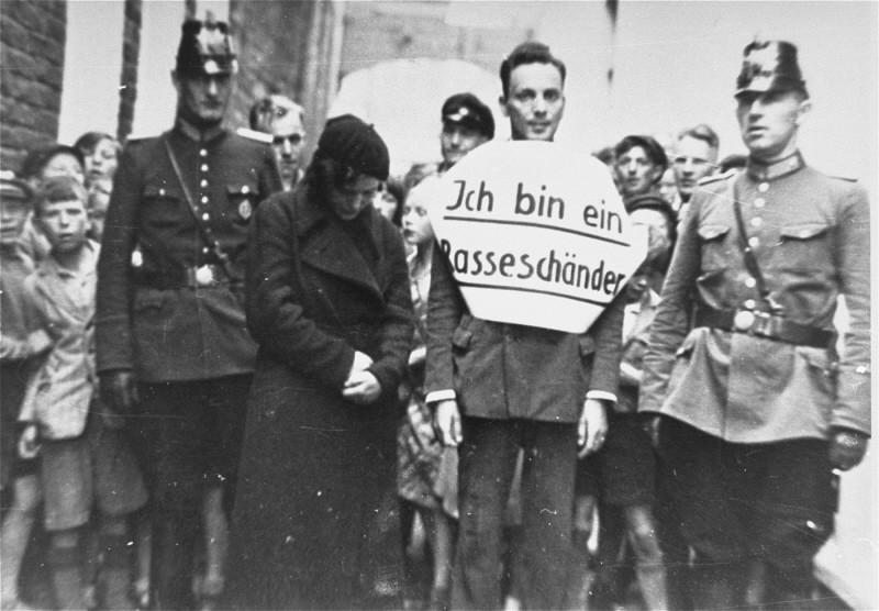 Public humiliation: "I am a defiler of the race." In this photograph, a young man who allegedly had illicit relations with a Jewish ...