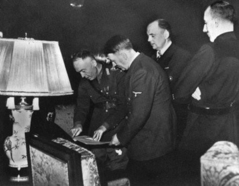 In Hitler's presence, Romanian ruler Ion Antonescu signs the Three-Power Agreement.