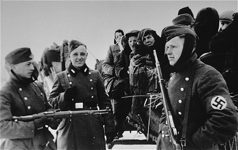 Young German soldiers assist in the deportation of Jews from the Zychlin ghetto to the Chelmno camp. [LCID: 18876]