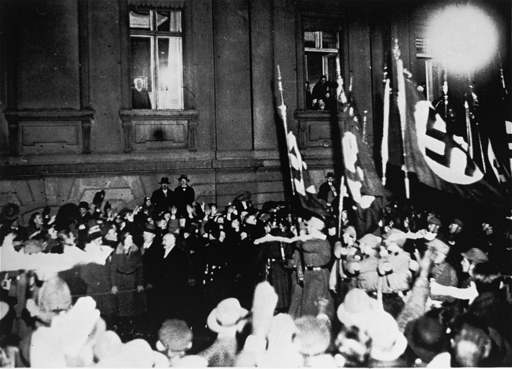 From a window in the Reich Chancellery, German president Paul von Hindenburg watches a Nazi torchlight parade in honor of Hitler's ...