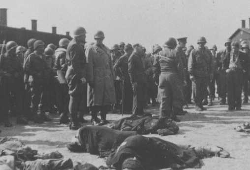 Generals Eisenhower, Patton, and Bradley view corpses of inmates at Ohrdruf, a subcamp of Buchenwald. [LCID: 10315]