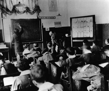 A Jewish Brigade soldier (center) teaching an elementary school class in a displaced persons camp. Germany, 1946. [Please contact Beth Hatefutsoth for copies of this photograph.]