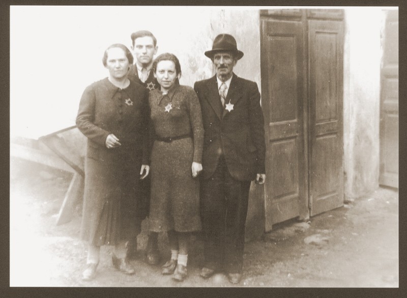 Portrait of the Weidenfeld family wearing Jewish badges in the Czernowitz (Cernauti) ghetto shortly before their deportation to Transnistria.