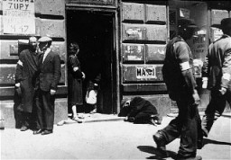 Escena en una calle del ghetto de Varsovia. El cartel a la izquierda anuncia: "Sopa en el patio, primer piso, depto. 47". Varsovia, Polonia, 1940-1941.