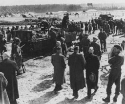 After liberation of the Bergen-Belsen camp, British soldiers forced German mayors from nearby towns to view mass graves. Bergen-Belsen, Germany, after April 15, 1945.