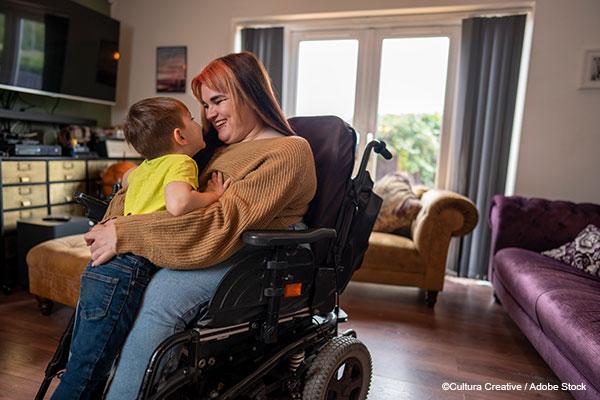 Disabled woman in wheelchair hugging her young son