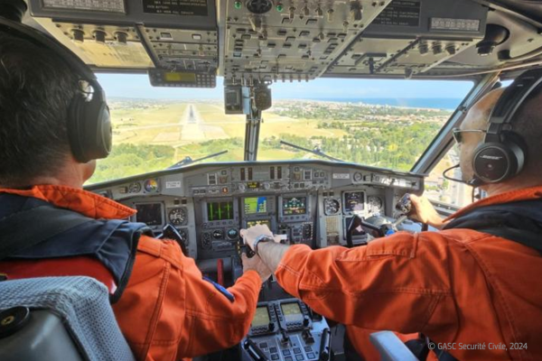 Two pilots in cockpit of firefighting plane